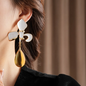 Detailaufnahme von Vintage-Blumenohrringen mit bernsteinfarbenen Tropfenanhängern