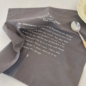 Detail of dark grey Scandinavian linen place mat with white minimalist typography text