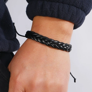 Men's minimalist black braided leather bracelet with adjustable drawstring on wrist