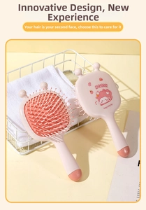 Pink hair massage brush featuring a cute cartoon design and flexible air cushion bristle base