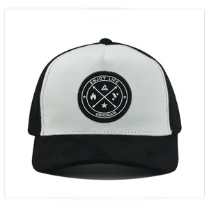 Detail view of monochrome trucker hat with suede texture and circular logo patch