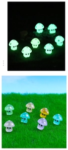 Luminous mushroom miniatures glowing in the dark and displayed on grass in daylight