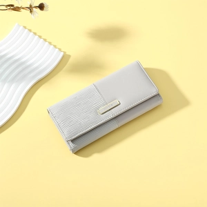 Detail of grey PU leather long wallet featuring wavy texture and gold metal buckle