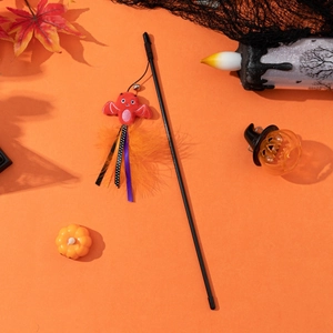 Halloween cat wand toy with bat plush, orange feathers and bells on a festive background