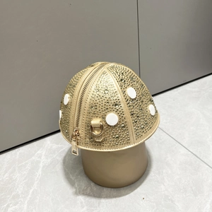 Macro detail of mushroom shaped evening bag with golden rhinestones and white dots
