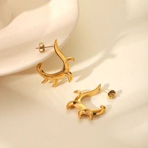Minimalist irregular C-shaped 18K gold plated stainless steel stud earrings on ceramic