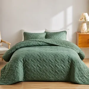 Detail of vintage green quilted bedspread and pillowcase set with large check pattern