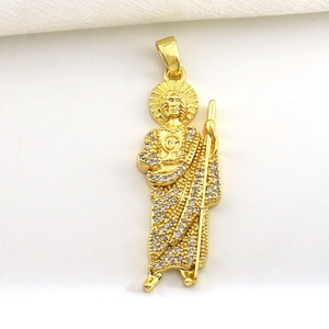 Macro shot of gold-plated Saint Jude pendant featuring sparkling white cubic zirconia stones