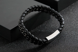 Detail of men's double-layered braided leather bracelet with silver stainless steel clasp