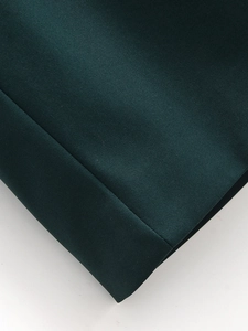Detailed macro view of dark green twill fabric showing high-quality textile texture