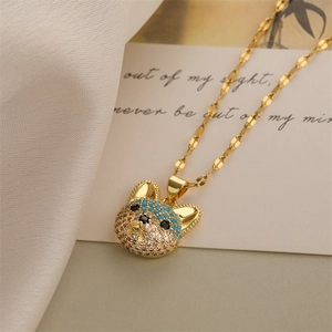 Macro detail of gold bulldog pendant encrusted with white and blue rhinestones