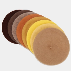 Flat lay showing a fan of warm-toned wool felt beret hats in various autumn colors