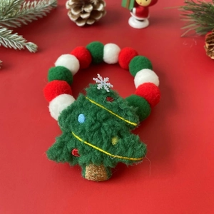 Macro shot of festive red, green and white Christmas pom-pom collar for dogs and cats