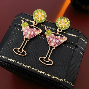 Detail of vintage cocktail glass earrings with pearls and crystals on a retro jewelry box