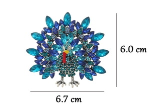 Detailed view of turkey brooch with blue rhinestones and dimensions of 6.7 cm by 6.0 cm