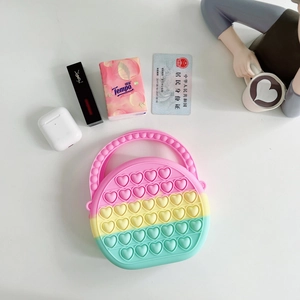 Detail of a colorful heart-shaped silicone pop-it purse with stress-relief bubbles