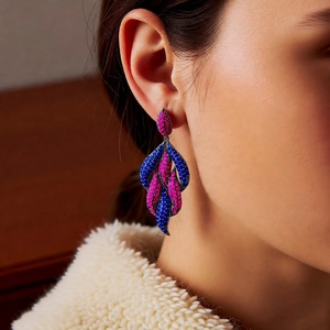 Detailed view of layered leaf-shaped drop earrings with vibrant pink and blue pavé stones
