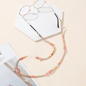 Detail view of handmade beaded eyewear chain with pastel beads and gold metal clasps