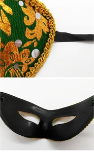 Close-up of Halloween masquerade mask with intricate gold embroidery and sequins