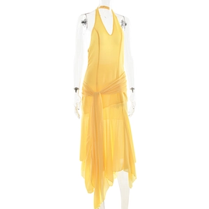 Detail of yellow halter neck chiffon dress with side draping and asymmetric hem