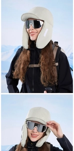 Detailed view of beige winter trapper hat with windproof earflaps for outdoor snow sports