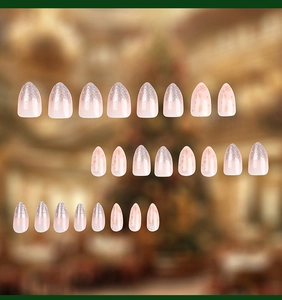 Macro view of 24 almond-shaped pink fake nails with silver glitter and snowflake designs