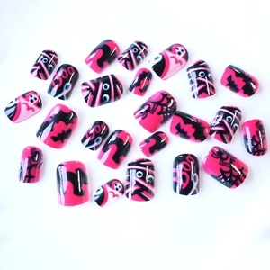 Pink and black Halloween press-on nails with cute mummy, ghost and spider web designs