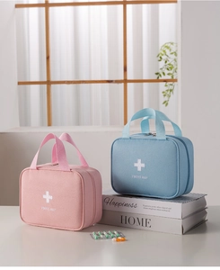 Detail of pink and blue portable first aid bags with sturdy handles and zippers