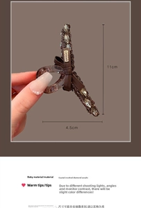 Dettaglio della pinza per capelli in cristallo nero da 11 cm con misure e design a fiocco