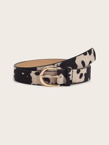 Detail view of cow print faux calf hair belt with elegant gold horseshoe buckle