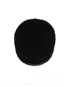 Detail view of the chunky knit texture and pattern of a black chenille winter beanie hat