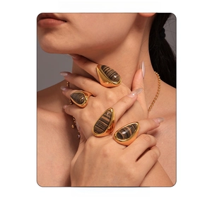 Macro detail of tear-drop rings with wood grain stone inlay in 18K gold plated finish