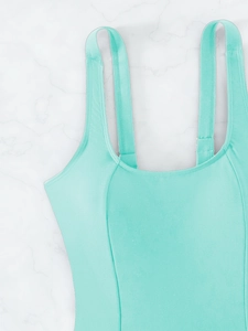 Close-up of mint green swimsuit featuring square neckline and high-density stitching details