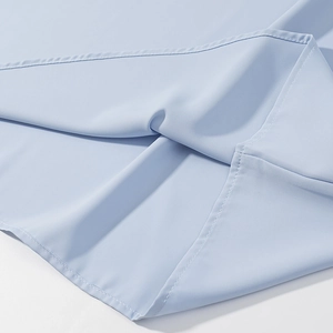Detailed close-up showing light blue fabric texture and precise side seam stitching