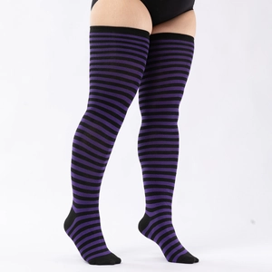 Detail of plus size purple and black striped over-knee socks showing stretch and texture