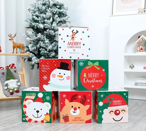 Detailed view of stacked Christmas gift boxes with festive cartoon patterns and merry greetings