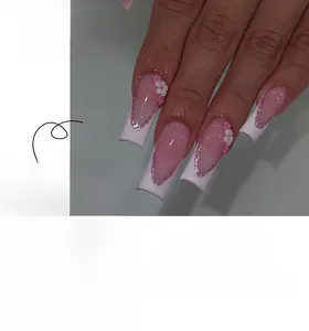 Detailed view of long square pink French ombre press-on nails with 3D floral accents