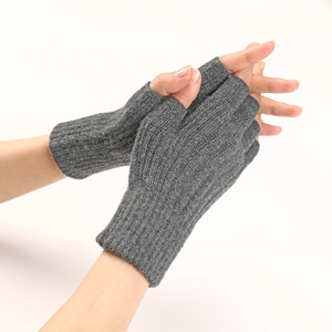 Close-up of grey cable knit fingerless gloves showing ribbed texture and warm material