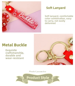 Detail of red liquid sand balloon keychain with gold clasp and glitter PVC strap