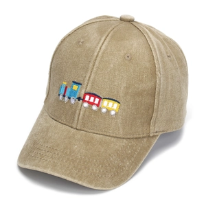 Close-up of colorful train embroidery and washed fabric texture on khaki baseball cap