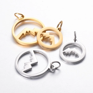 Detail of gold and silver hollow circular mountain pendants for jewelry making
