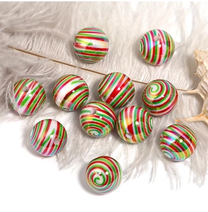 Macro shot of colorful spiral stripe acrylic beads on white feathers for DIY jewelry making