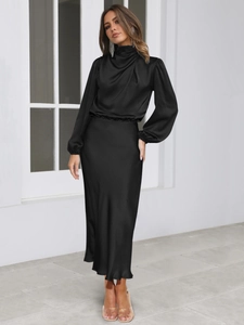 Detail of elegant black satin fabric showing premium glossy texture and soft draping