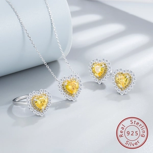 Detailed macro of S925 silver jewelry set featuring heart-cut yellow carbon diamonds
