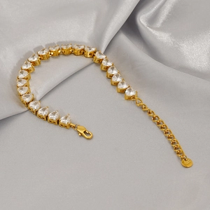 Detail of 18K gold plated tennis bracelet with heart-shaped cubic zirconia and lobster clasp