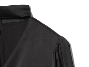 Detailed view of black satin V-neck blouse with elegant pleated shoulders and smooth texture
