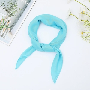 Macro view of bright blue chiffon silk scarf with lightweight and translucent texture