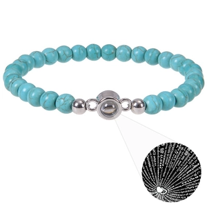 Detail of turquoise beaded bracelet with silver projection charm showing I Love You in 100 languages