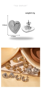 Detailed size view of gold and silver heart-shaped textured earrings on marble