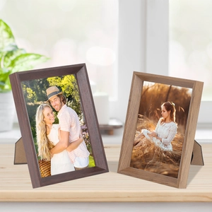 Detail of vintage solid wood picture frames showing natural grain and back support stand